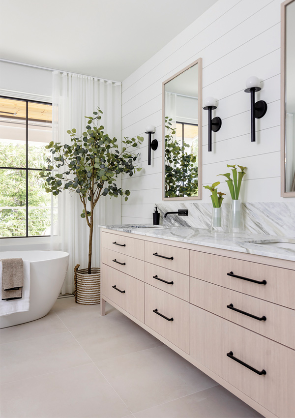bathroom with marble countertop vanity and bath tub. Design by Knight Varga Interiors | Photography by Janis Nicolay 